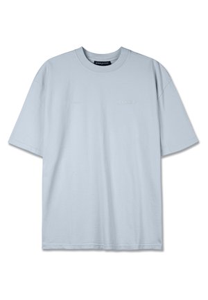 T-shirt in cotone azzurro chiaro con vestibilità rilassata, scollo rotondo, maniche corte e discreta branding "PEGADOR" sul davanti.