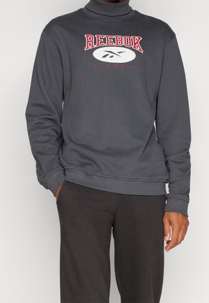 Felpa grigia con colletto alto, caratterizzata da un logo Reebok rosso e bianco. Realizzata in tessuto morbido, con maniche lunghe e polsini e orlo a coste.