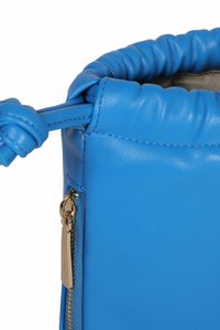 Borsa a tracolla in pelle blu con una parte superiore arricciata, caratterizzata da un dettaglio in zip dorata e una tracolla annodata, evidenziando una texture liscia.