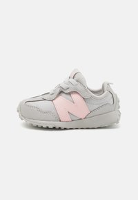 Grey sneaker with a pink "N" logo, featuring a textured upper, laces, padded collar, and a rubber outsole with traction pattern.