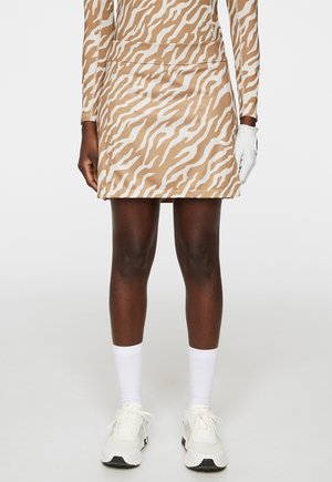 Beige Rock mit einem weißen Zebra-Streifenmuster, aus glattem Material, mit elastischem Bund und taillierter Passform.