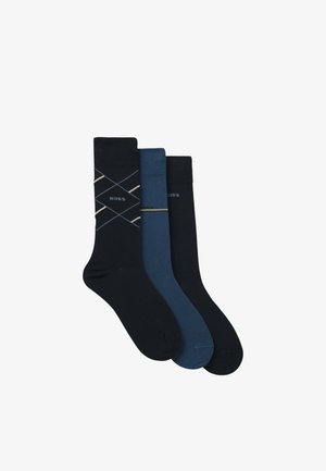 Tre paia di calzini: uno blu scuro con un motivo a rombi, uno blu scuro uniforme e uno blu navy uniforme. Tutti presentano l'etichetta "BOSS."