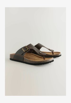 Infradito in pelle marrone con una soletta in sughero texturizzato, dettaglio con fibbia regolabile e suola in gomma per una migliore aderenza.