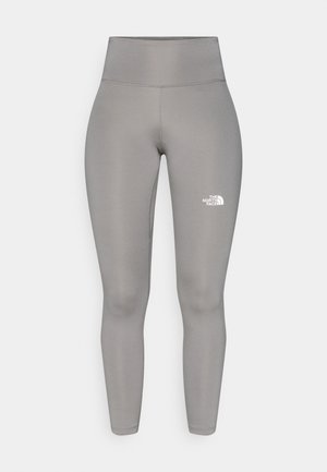 Grijze leggings van rekbaar materiaal met een hoge taille, voorzien van een wit logo op het onderbeen. Gladde textuur, slank ontwerp.