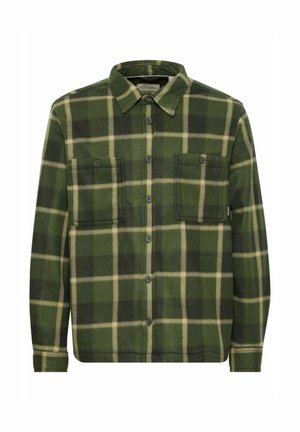 Green and black plaid flannel shirt with a button-down collar, two front pockets, and textured fabric. Features black buttons and contrasting light lines.