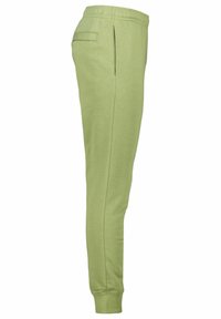 Ljusgröna joggers gjorda av mjukt material, med sidoficka, elastisk midjeband och avsmalnande ben med mudd vid anklarna.