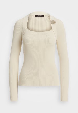 Cream ribbed long-sleeve knit top with square neckline and adjustable buckle strap detail on right shoulder.