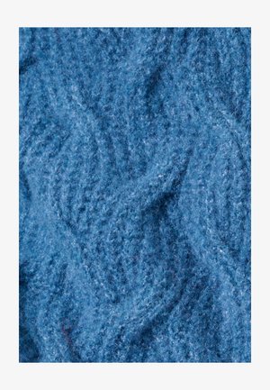 Tissu en laine texturé bleu ciel présentant un motif de vagues. Surface douce et duveteuse avec des variations de profondeur de couleur, créant un intérêt visuel.