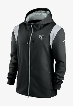 Schwarze Zip-Hoodie aus glattem Stoff, mit grauem Innenfutter in der Kapuze, weißen Streifenakzenten auf den Schultern und dem Raiders-Logo auf der Brust.