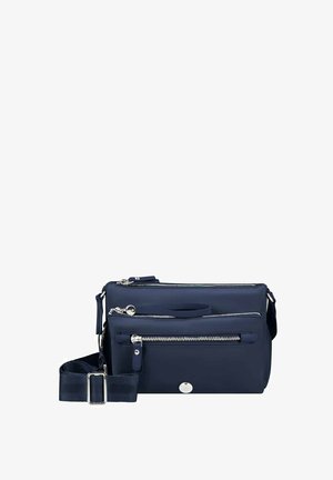Navy blue crossbody bag with three silver zipper compartments, adjustable strap, and small round logo on front pocket.