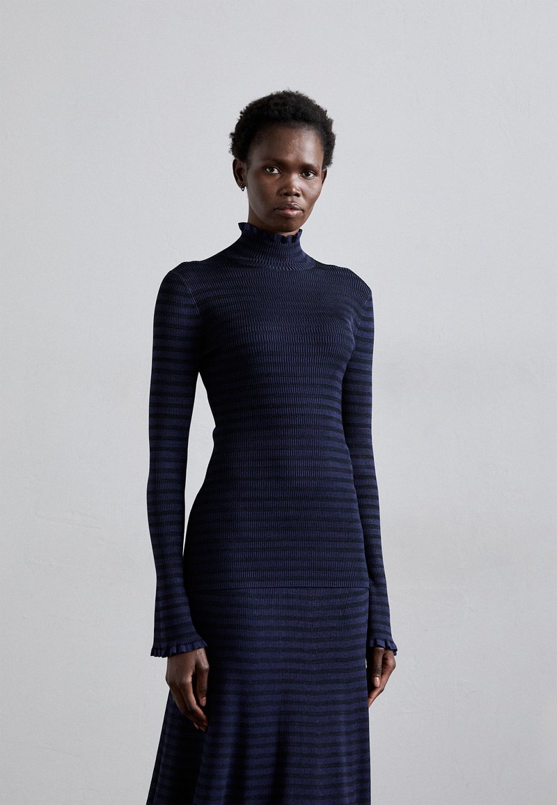 Long-sleeve, fitted dress in dark navy with subtle horizontal stripes. Features a high neckline and ruffled cuffs, made of textured fabric.