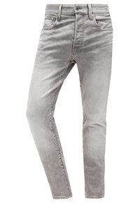 Jean en denim gris clair coupe slim, avec cinq poches, passants pour ceinture, fermeture par bouton, et détails de lavage délavé.