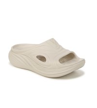 Light beige slip-on shoe made of soft rubbery material. Features open toe design, textured upper, and wavy sole pattern for grip.