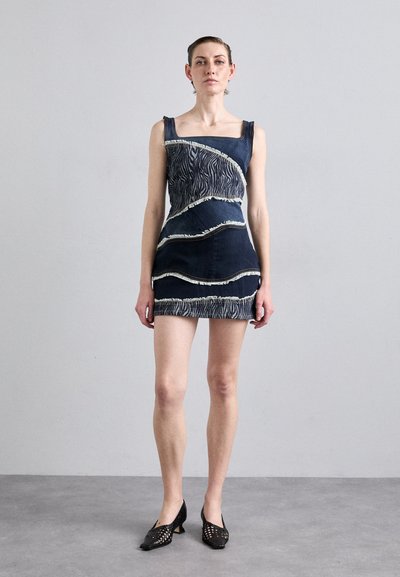 Denim dress with a square neckline, featuring contrasting wavy patterns in white and textured fringes, fitted shape, and above-the-knee length.