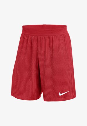 Pantaloncini sportivi rossi realizzati in tessuto testurizzato. Presentano una vita elastica e un piccolo logo Nike bianco sulla parte bassa della gamba sinistra.