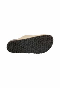 Sandal with a beige upper and a textured black rubber sole featuring a hexagonal pattern for grip. Thin design with an open toe.
