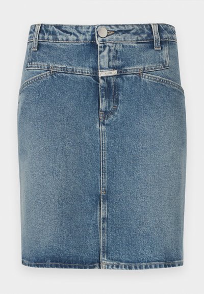 Denim skirt in light blue wash, featuring a fitted design, five-pocket styling, front button closure, and visible stitching details.