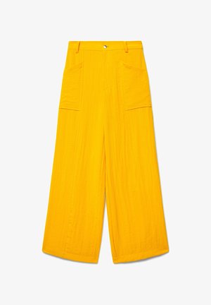 Bright yellow wide-leg pants with high waist, large front patch pockets, button and zipper closure, made of textured fabric.