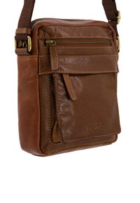 Braune Leder Umhängetasche mit Reißverschluss, einer vorderen Tasche und verstellbarem Stoffgurt. Verfügt über eine strukturierte Oberfläche und genähte Akzente.