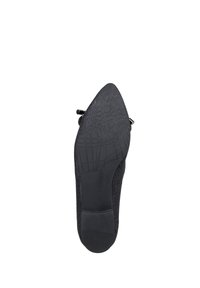 Zwarte hiel schoen met een spitse neus, textuur bovenkant en een gladde rubberen zool met een geribbeld patroon voor grip.