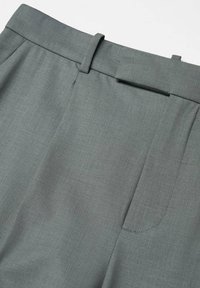 Pantalon en tissu gris avec passants de ceinture et fermeture frontale dissimulée, présenté de la taille vers le bas.
