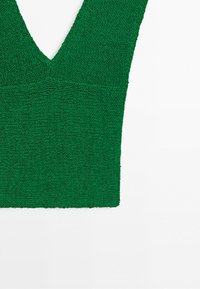 Green knitted sleeveless top with a deep V-neck and textured stitching on a white background.