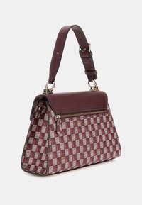 Red and white patterned handbag with a structured shape, a top handle, zip closure, and gold hardware accents. Smooth leather trim.