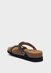 Sort flip-flop sandal med en polstret korksål, pyntet med farverige perledetaljer på stropperne, og en tekstureret gummiudsol.