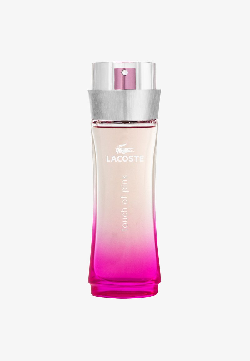 Il profumo Lacoste Touch of Pink in una bottiglia di vetro trasparente con un gradiente da trasparente a rosa, coronata da un tappo argentato.