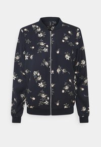 Veste bomber bleu marine avec fermeture éclair frontale et motif floral rose clair, col, poignets et bas côtelés.