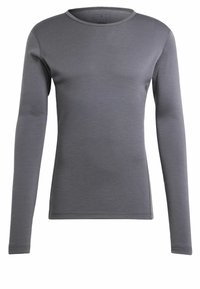 Chemise à manches longues grise en tissu doux et extensible. Elle présente un col arrondi et un design ajusté avec des coutures minimales. Aucune logo visible.