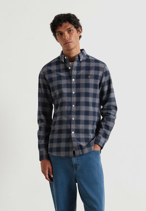 Navy and gray checkered button-up shirt with long sleeves, featuring a small embroidered logo on the chest and a classic collar design.