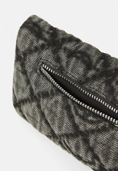 Borsa in tessuto trapuntato nero e grigio con una tasca con zip. La texture è morbida con un motivo rigato sulla superficie.