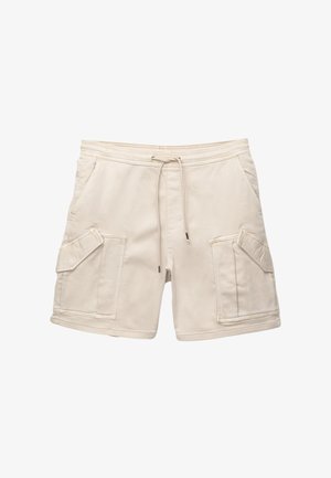 Pantaloni cargo beige con cintura elasticizzata e cordoncino. Presentano due ampie tasche frontali con alette inclinate e un morbido tessuto di cotone.