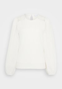 Blusa bianca lavorata a maglia con scollo rotondo, maniche a palloncino e dettagli in pizzo sulle spalle. Tessuto morbido e strutturato con vestibilità rilassata.