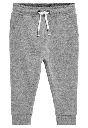 Pantalon de survêtement gris en tissu doux et texturé. Caractérisé par une taille élastique avec cordon de serrage, des poches latérales et des poignets fuselés.