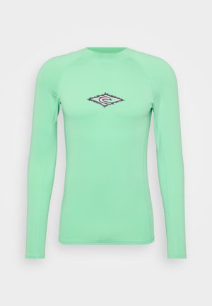 Langarm rash guard van mintgroene stof. Heeft een logo in een diamantsvorm op de borst en beschikt over platte naden voor comfort.