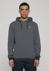 Marineblauwe en wit gestreepte hoodie met capuchon met trekkoord, geribbelde boorden en zoom. Eenvoudig logo op de borst, zachte stof, casual pasvorm.