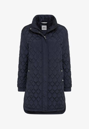 Navy quilted long jacket with a high collar, featuring a zip front, two side pockets, and elastic cuffs for added comfort.