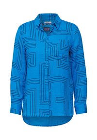 Chemise bleue à manches longues avec boutons, col, poche sur la poitrine gauche et motifs géométriques carrés noirs.