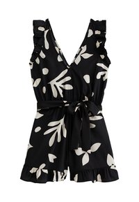 Zwarte bloemen romper met witte bladerenpatronen, ruches op de schouders, een diepe V-hals en een tailleband. Uitlopende pijpen met een rucheszoom.