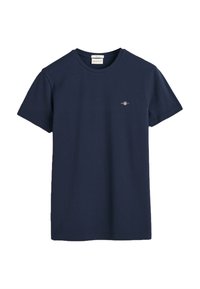 T-shirt in cotone blu navy con maniche corte, scollatura a girocollo e un piccolo logo ricamato sul petto. Tessuto liscio, vestibilità standard.