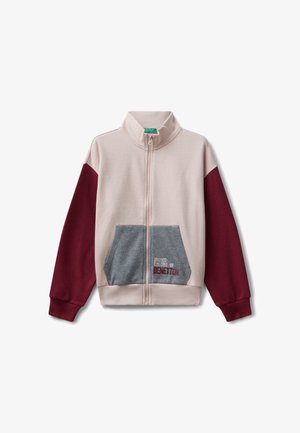 Zipperowana kurtka w jasnoróżowym kolorze z bordowymi rękawami i szarym kieszonką. Posiada wyszywane logo „United Colors of Benetton” na kieszeni.