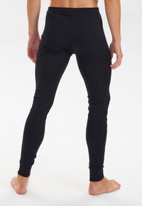 Black stretch leggings made of soft material, featuring a fitted design, ribbed cuffs, and a smooth surface. No visible patterns or hardware.