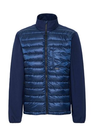 Veste navy avec un devant matelassé et des manches lisses, fermeture éclair, col montant et une petite poche sur la poitrine gauche. Texture douce.