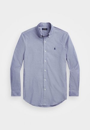 Lyseblå langærmet skjorte med knapper og knapfast krave samt lille broderet Polo Ralph Lauren-logo på brystet.