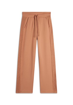 Pantaloni a gamba larga color pesca realizzati in tessuto morbido, con vita regolabile e dettagli laterali intrecciati. Inclusa una tasca su entrambi i lati.