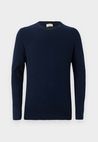 Pull bleu marine en tissu doux, avec un col ras du cou et des manches longues. Design simple avec une texture en maille fine et un ourlet côtelé.