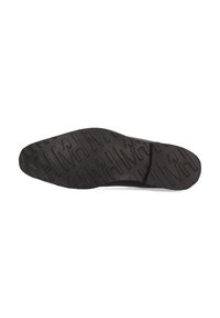 Suela de zapato de goma negra con un patrón de agarre texturizado, que presenta diseños geométricos y contornos distintivos para una mejor tracción.