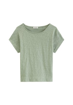T-shirt pour femmes à manches courtes de couleur vert clair avec un col rond, fabriqué en tissu de coton slub, présenté sur un fond blanc.